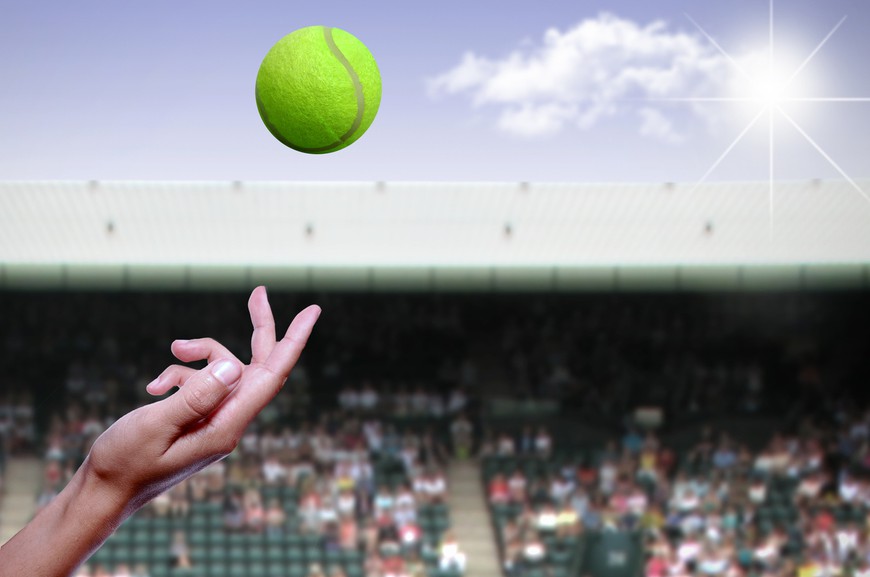 Tennis ball being tossed in the air during a match - 2023 Guide to Wimbledon Betting: Odds, Tips, and Predictions