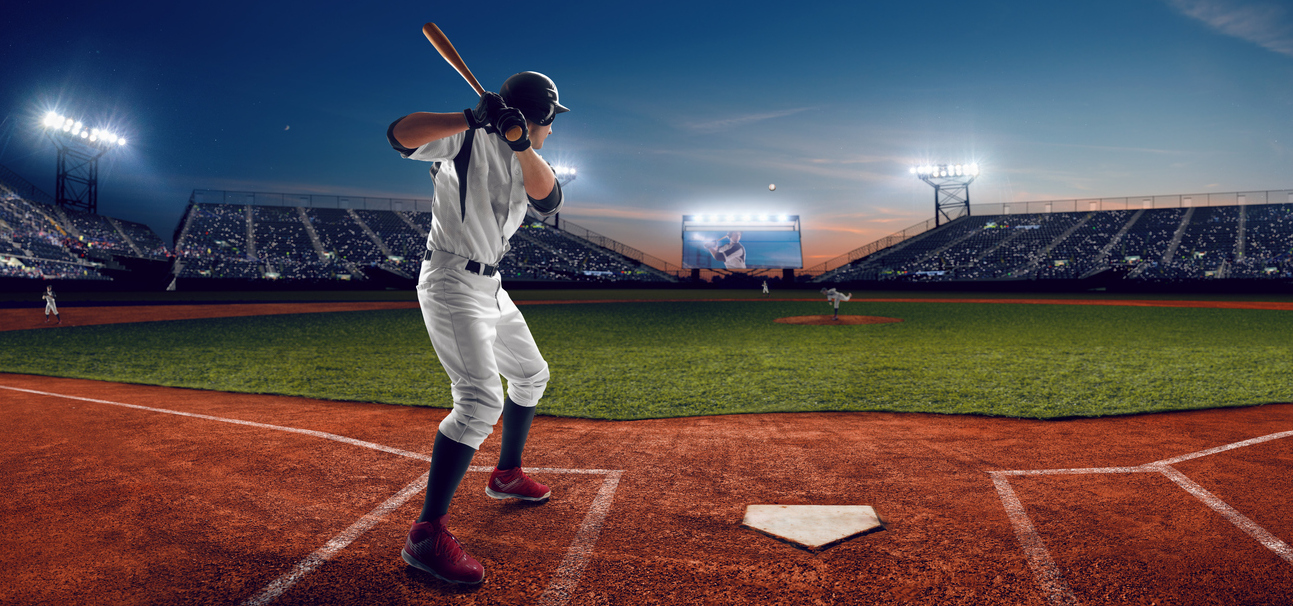 Baseball player at professional baseball stadium in evening during a game. What Are the Best MLB Betting Apps for US Sports Bettors?