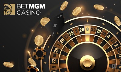 Black and gold poker chips, black and gold playing cards, and a black and gold roulette wheel are seen on a black background. in the upper left corner is the BetMGM Casino logo in honor of its recent Ontario online casino launch.