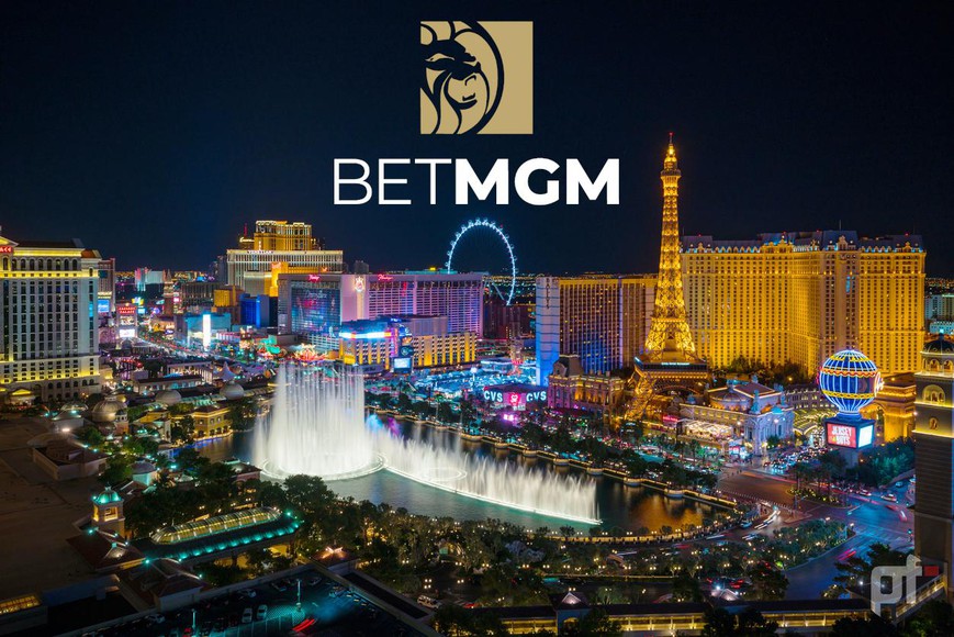 overhead view of las vegas at night. you can see the big ferris wheel, eiffel tower, bellagio fountains, and other casinos and buildings all lit up against the night sky. the betmgm logo is on the top of the image.