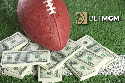 a football is seen on grass with stacks of money around it. the BetMGM logo is in the upper right. Score Big this NFL Season with Incredible BetMGM Bonuses!
