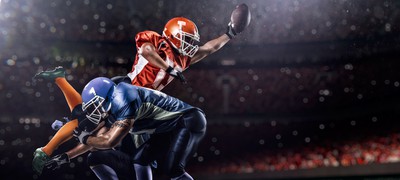 American Football players in action, playing a game in a stadium. Expert NFL Picks and Predictions