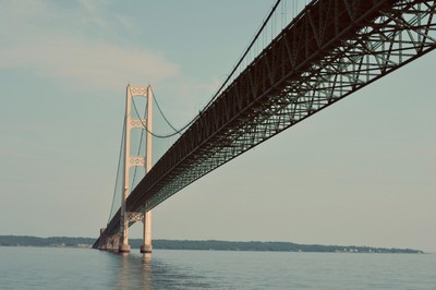 Mackinac Bridge is seen stretching over blue water and against blue skies. The Mackinac Bridge is one of the longest suspension bridges in the US. Much like the bridge, MI Online Poker might be connecting to other states via an interstate compact soon.