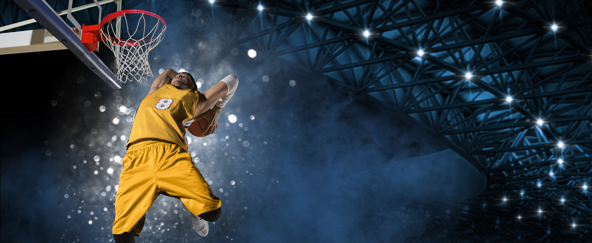 a basketball player wearing a yellow uniform is seen soaring through the air as he dunks the basketball in the basket. NBA Daily Predictions & Expert Picks