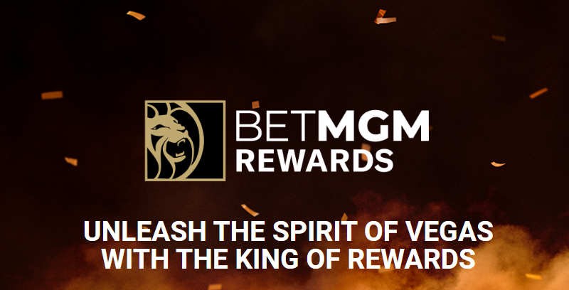 Promo image: brown background with orange smoke, Text says "BetMGM Rewards: Unleash the Power of Vegas With the King of Rewards", to promote the new MGM casino, sportsbook, & resorts loyalty program which went live on February 1, 2022.