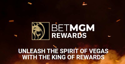 Promo image: brown background with orange smoke, Text says "BetMGM Rewards: Unleash the Power of Vegas With the King of Rewards", to promote the new MGM casino, sportsbook, & resorts loyalty program which went live on February 1, 2022.