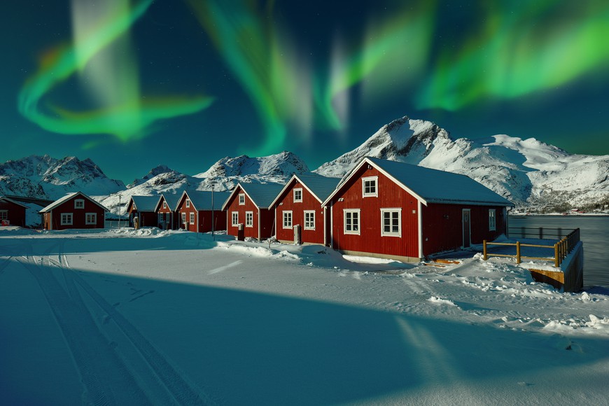 PokerStars to Exit Norwegian Market: The Why and When - PokerStars announces its departure from the Norwegian market, citing "commercial reasons" as regulatory actions intensify. winter scenery with traditional Norwegian red wooden houses on the shore of Sundstraumen strait at night with northern lights. Location: Lofoten; Norway, Europe. PokerStars to Exit Norwegian Market: The Why and When