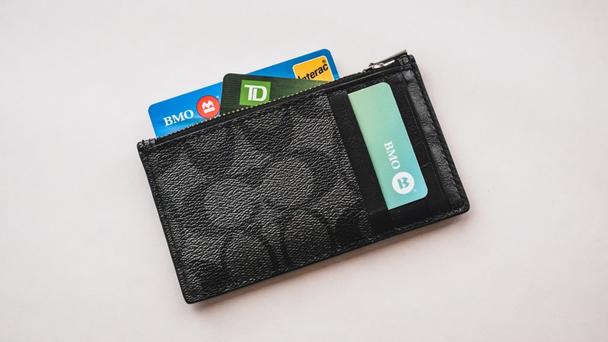 A wallet with credit cards sticking out of it, including an Interac debit card. Interac at Online Casinos in Ontario: How Does It Work?