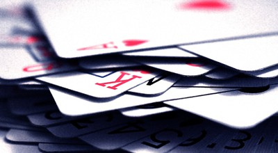 a close up of a pile of playing cards with a shallow depth of field, focus on the king of hearts in the middle of the pile. Come Monday, Ontario online poker will be split: those operating in the new regulated space a& those continuing to operate offshore