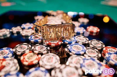 A WSOP gold bracelet sits atop a pile of black, blue, and red poker chips on a poker table. Thanks to large tournaments, lobby changes, and its biggest rival PokerStars PA's outage, WSOP PA has hit an all-time high in the PA online gaming market