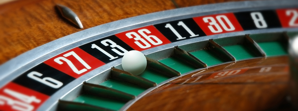 Closeup of a roulette wheel. How to Play Roulette: Basic Rules, House Edge, and Strategy