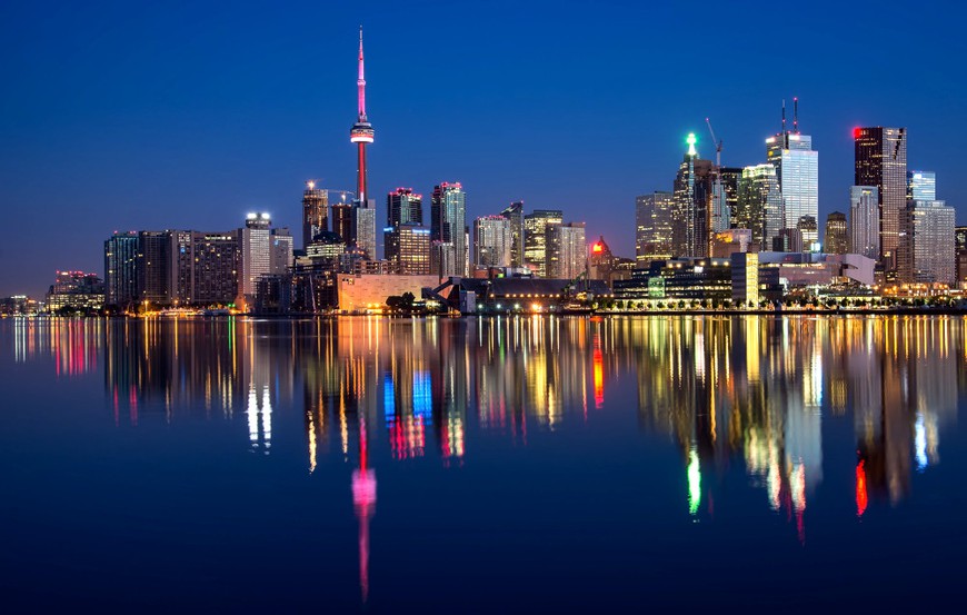 Toronto skyline is seen at night. CN Tower and skyscrapers rise up from the shore of Lake Ontario. Ontario, lit up with lights and neon, Canada's biggest province, is set to launch its new regulated iGaming market on April 4.