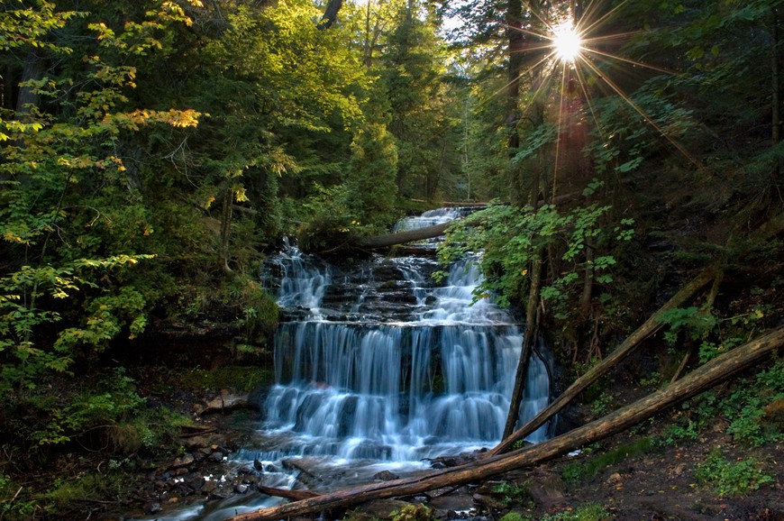 a beautiful scenic waterfall is seen in the woods of national park in Michigan. Michigan Online Poker Exposed: 5 Surprising Facts You Didn't Know