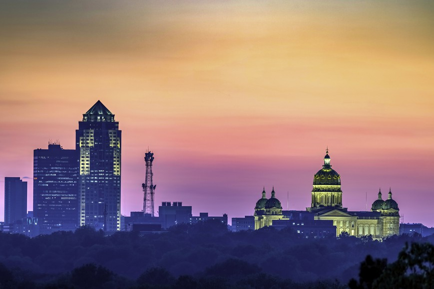 Close-up of the Des Moines skyline and Iowa State Capitol Building at sunset, with beautiful orange and pink colors spread across the sky. Could the next state for US Online Poker be Iowa?